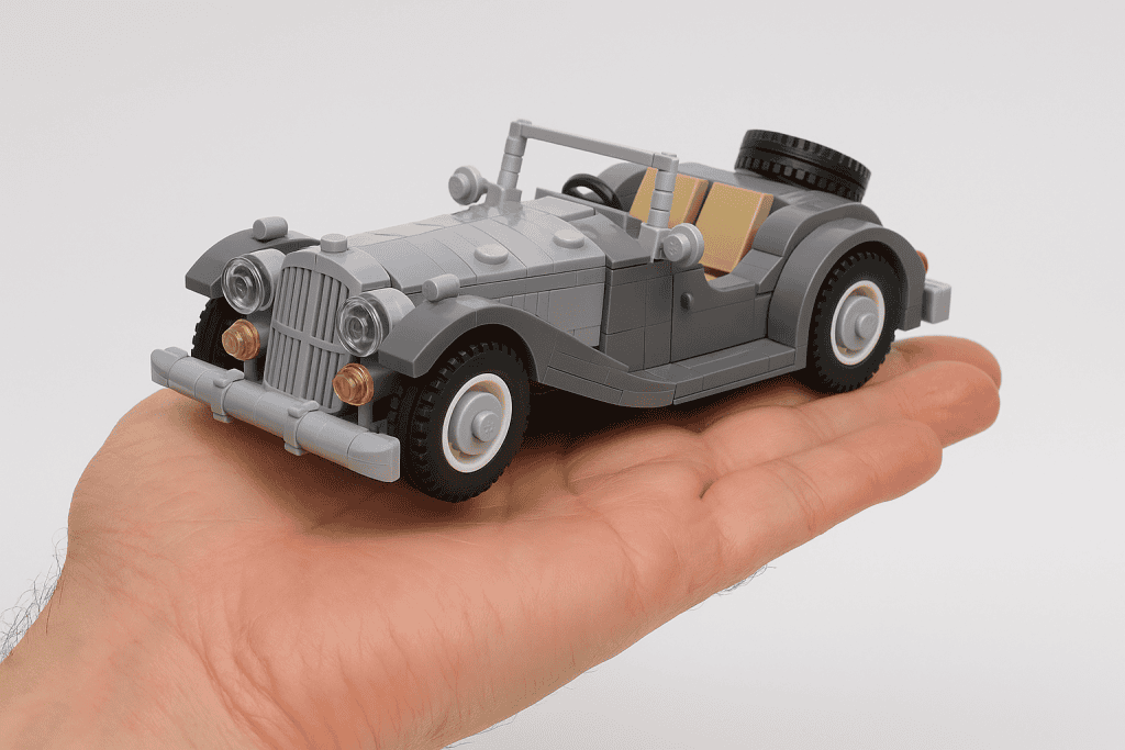 1. LEGO vintage car model in gray with detailed features and white tires, held in hand.