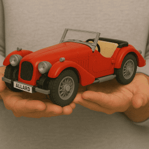 Vintage toy car LEGO model in red with detailed design and license plate "ALLARD".