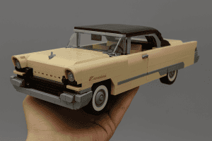 A LEGO model of a vintage beige Lincoln car with a black roof, detailed with classic design elements.