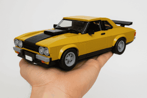 LEGO yellow sports car model hand-built with detailed features.